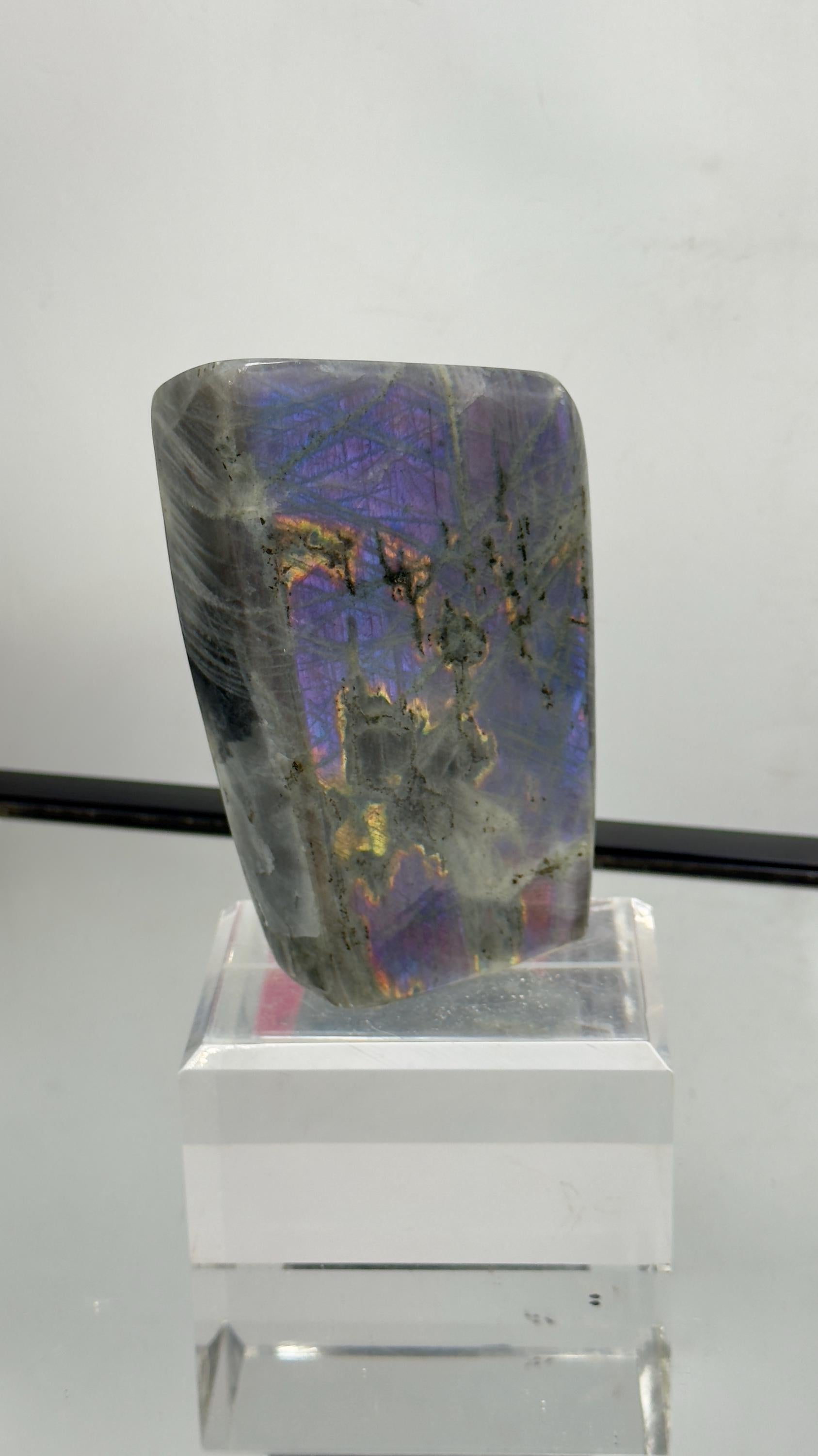 Stunning polished purple Labradorite gemstone with bright violet and blue flash – unique collector’s piece.