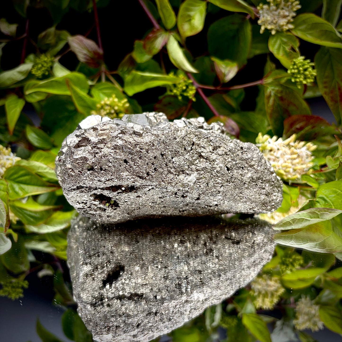 Back view of a large Pyrite cluster highlighting its bright metallic lustre.