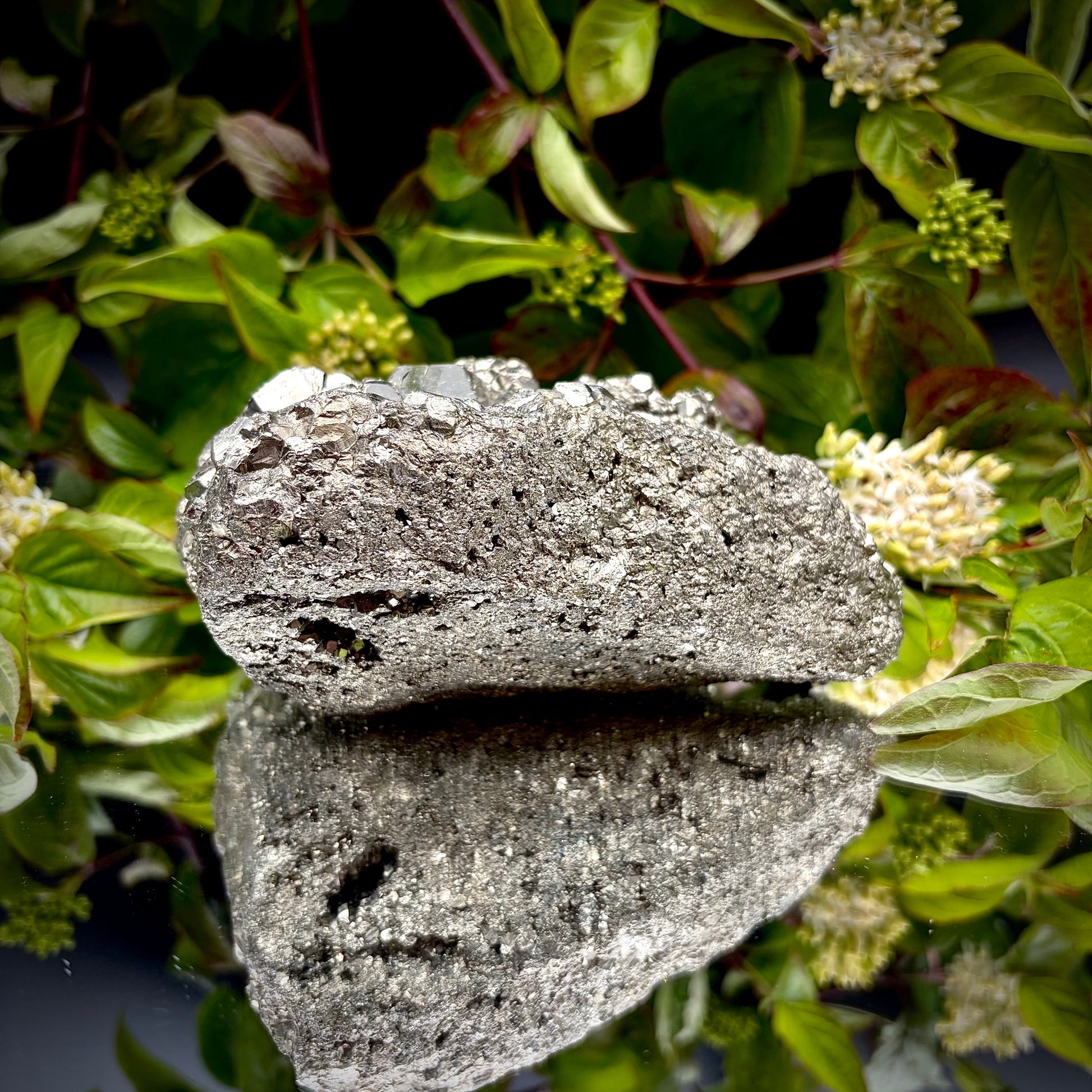 Back view of a large Pyrite cluster highlighting its bright metallic lustre.