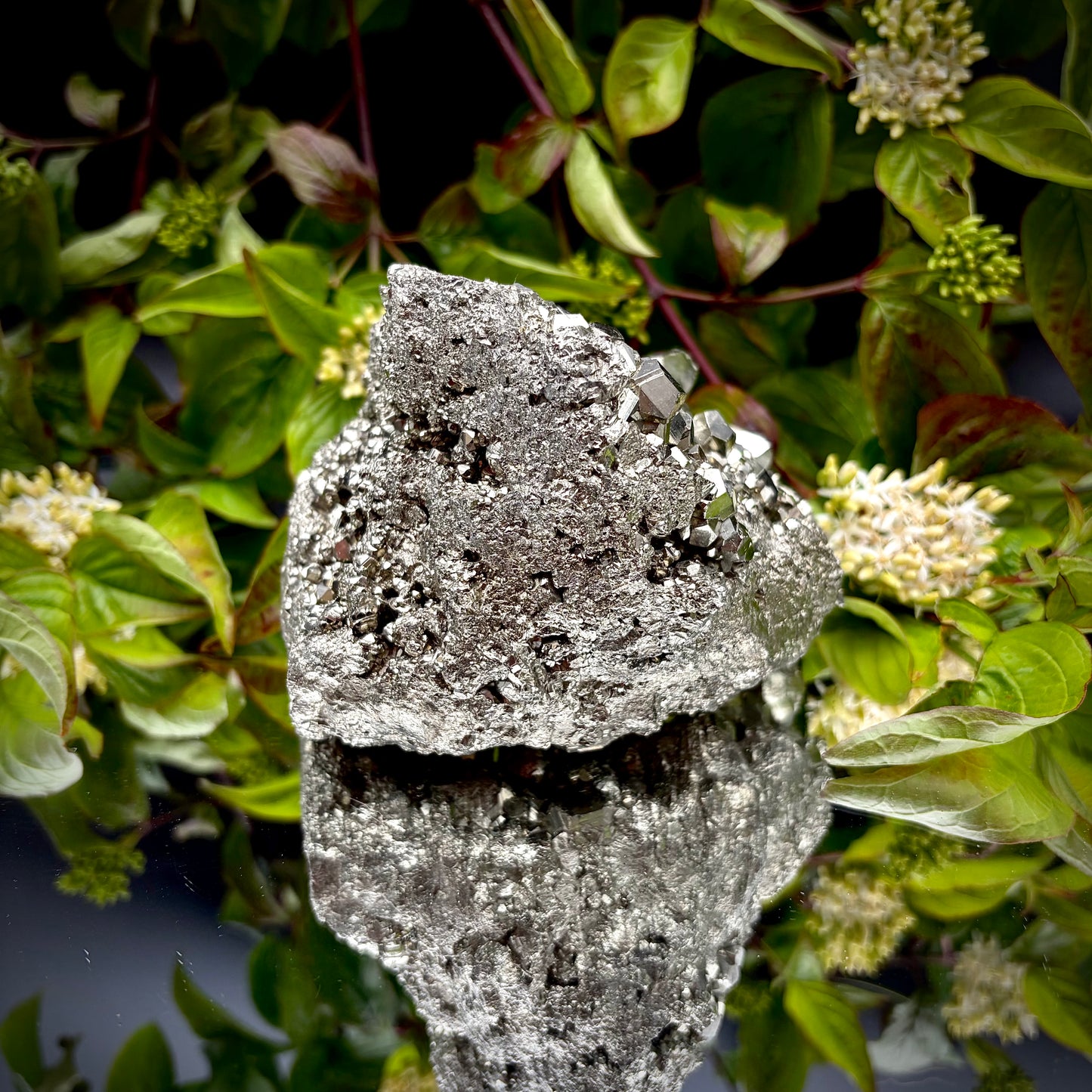 Back view of a large Pyrite cluster highlighting its bright metallic lustre.