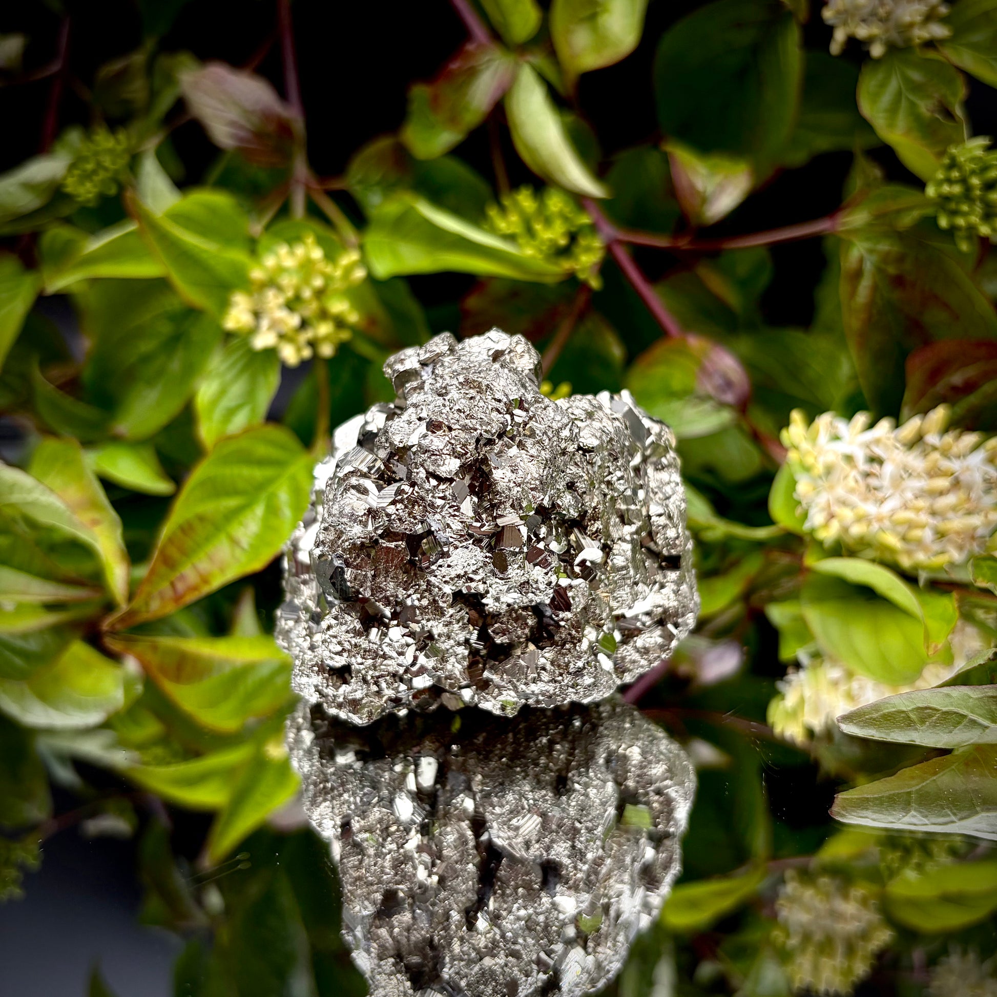 Back view of a large Pyrite cluster highlighting its bright metallic lustre.