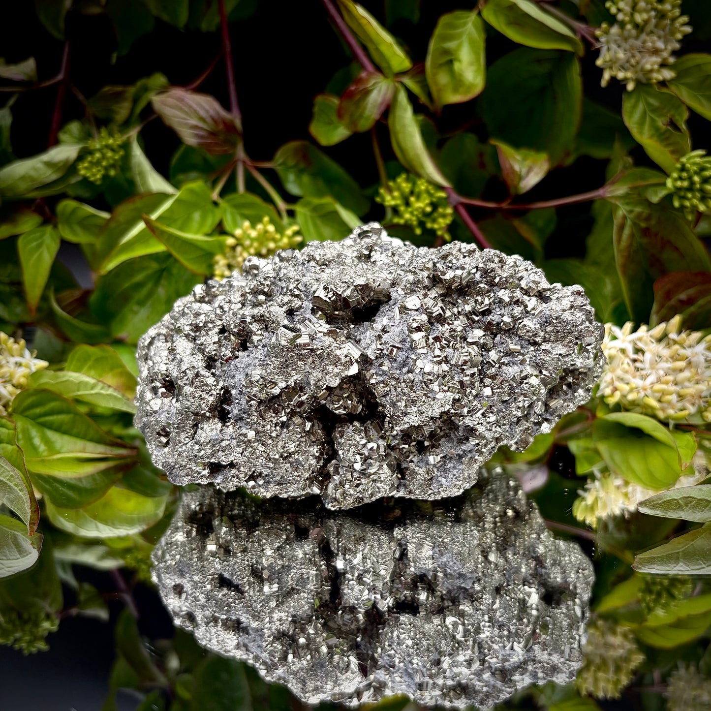 Back view of a large Pyrite cluster highlighting its bright metallic lustre.