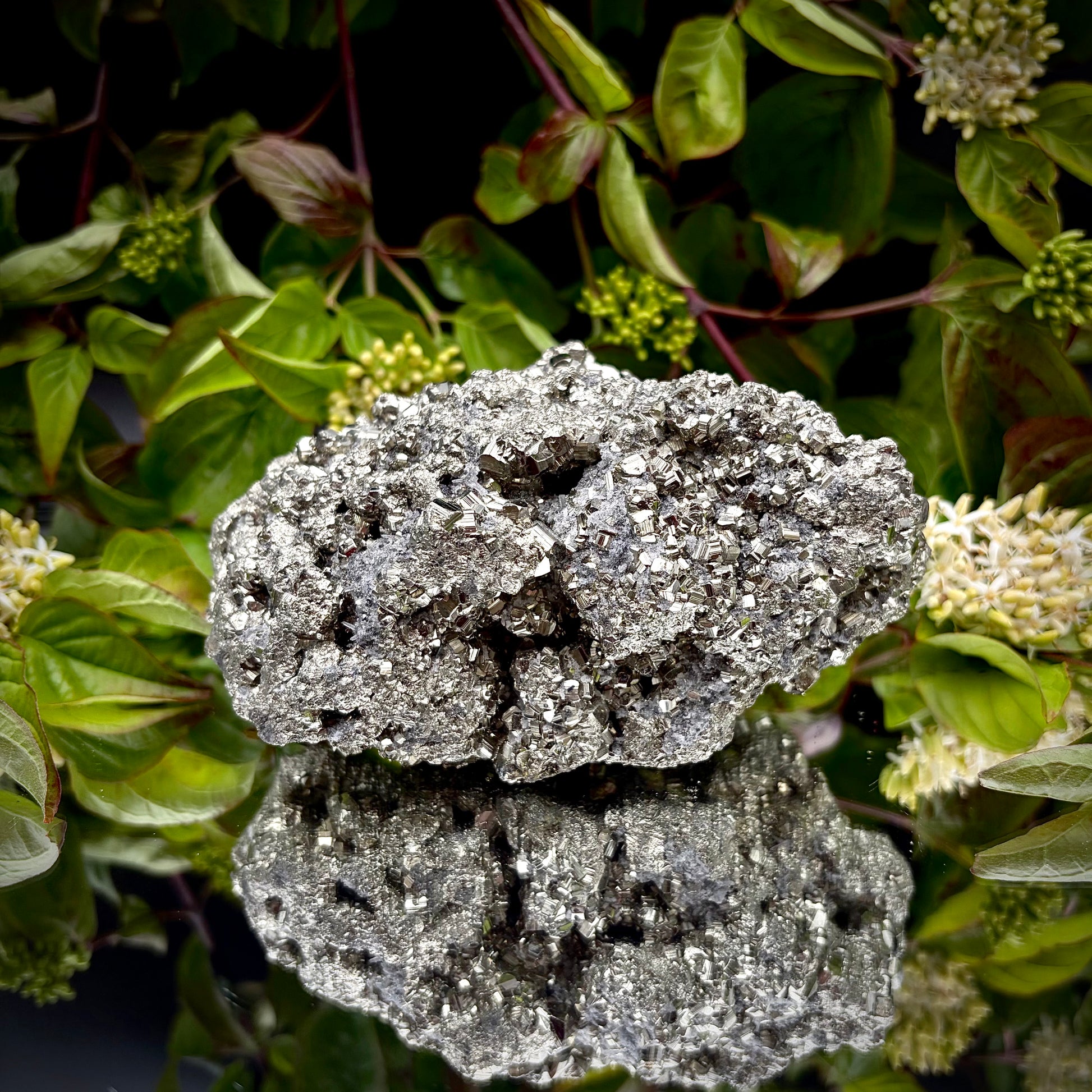 Back view of a large Pyrite cluster highlighting its bright metallic lustre.