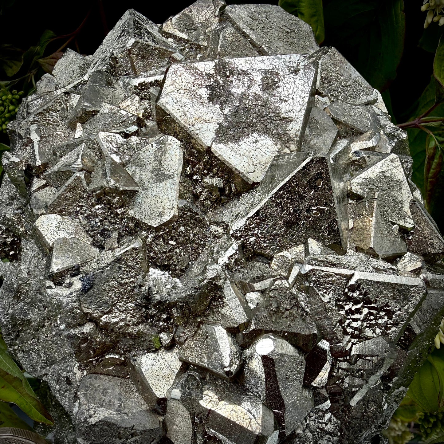 Close-up of multi-faceted geometric octahedral crystal formations on a raw Pyrite specimen.