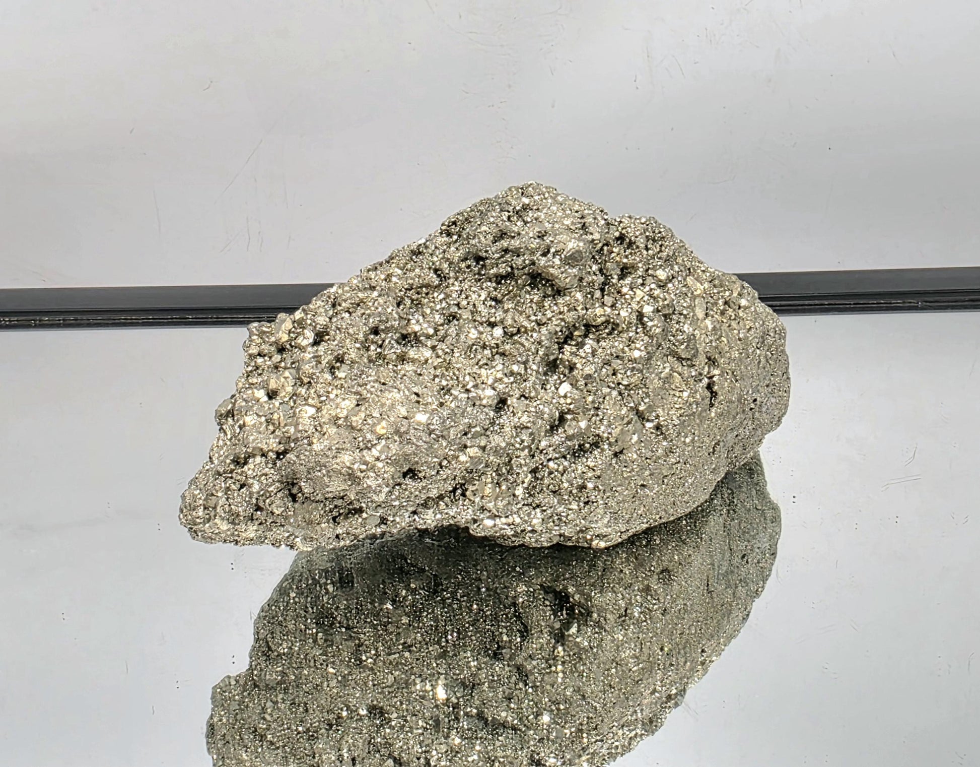 Sparkling golden Pyrite cluster with strong reflection.