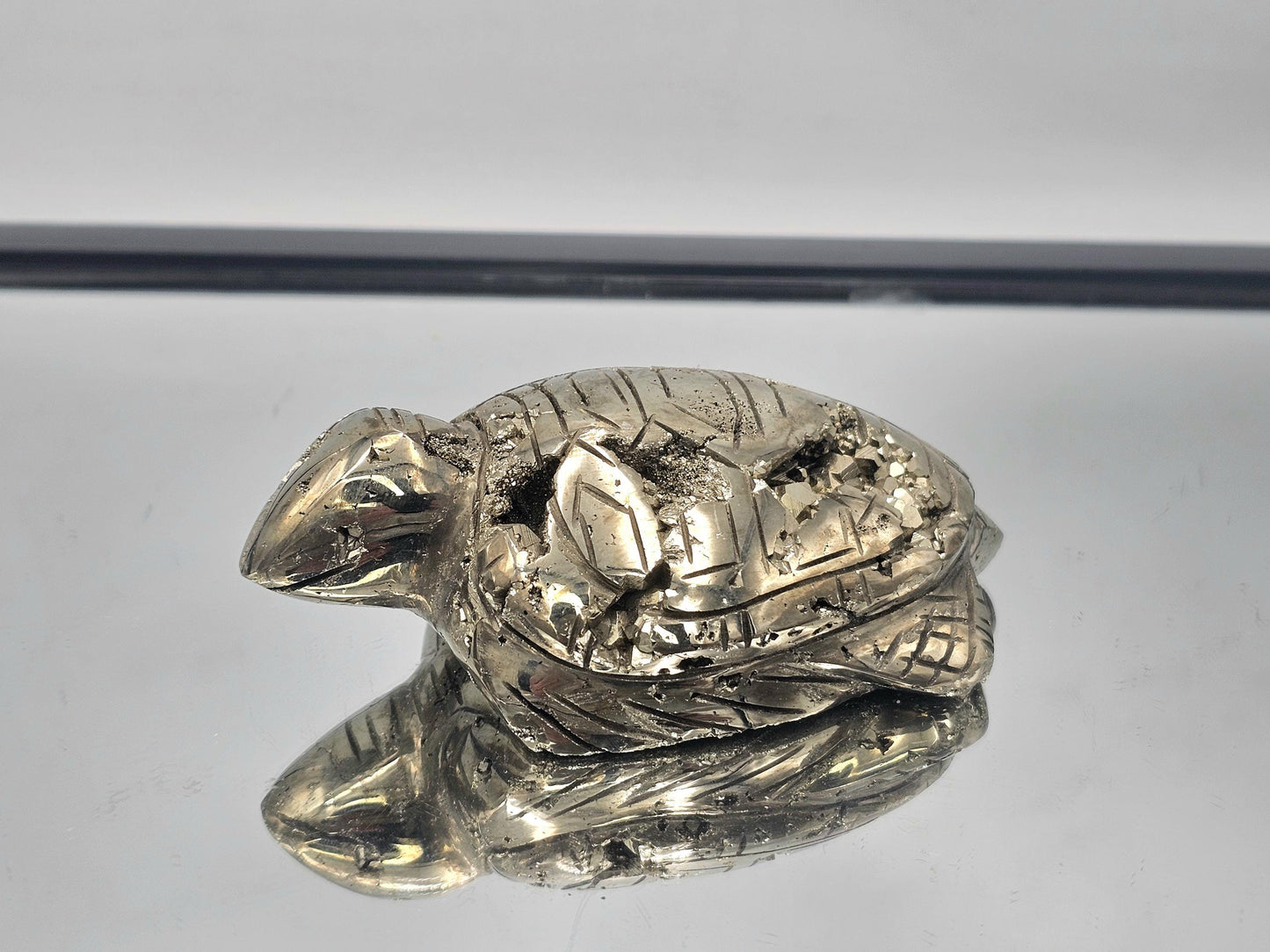 Pyrite Crystal Turtle Carving displayed as part of elegant home decor.