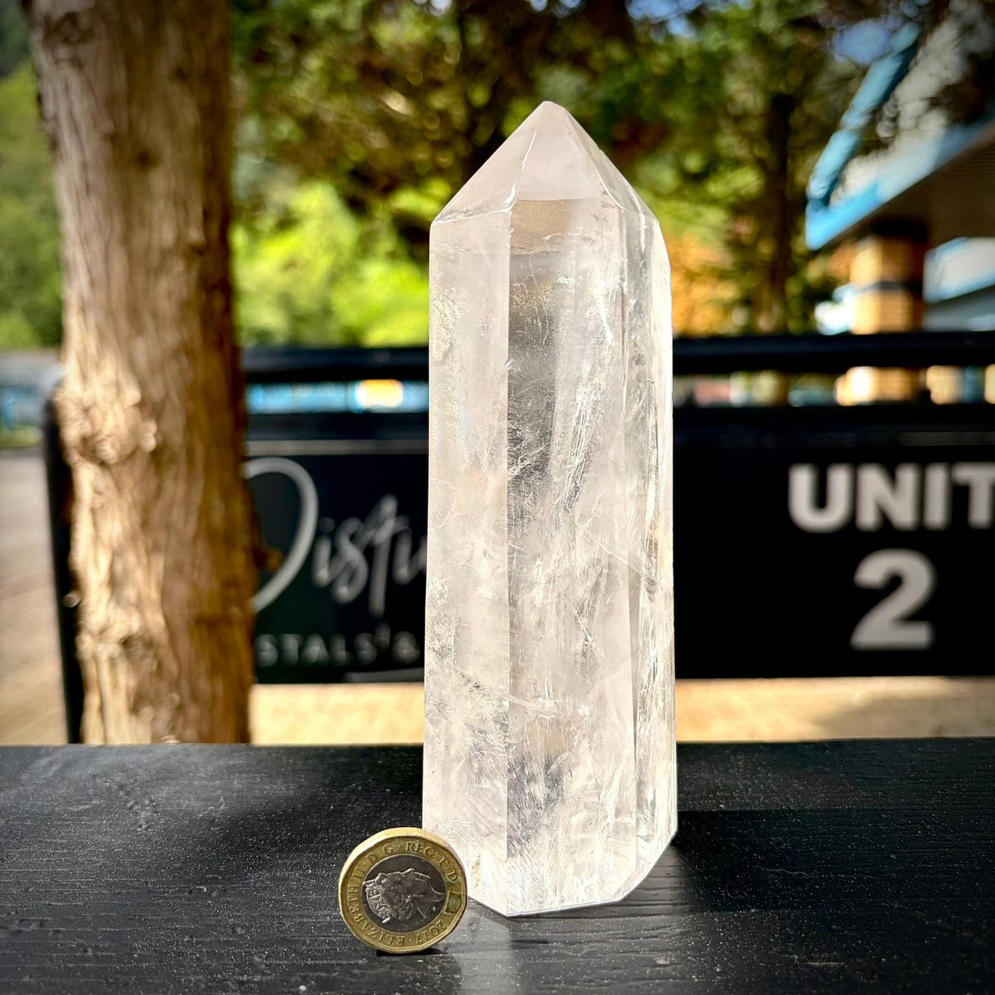 Quartz prism crystal display piece with polished finish and natural internal textures.