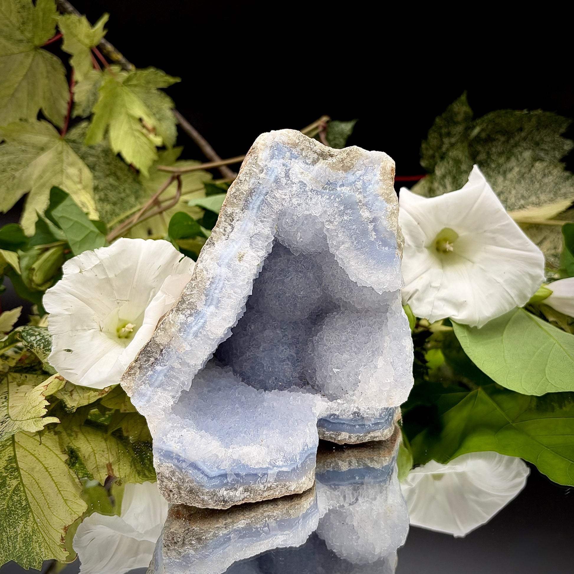 Natural Blue Lace Agate geode specimen with a prominent hollow cavity showing off light blue crystalline bands.