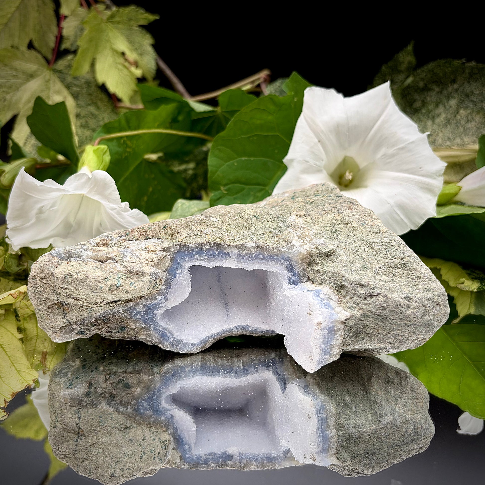 Natural Blue Lace Agate geode specimen with a prominent hollow cavity showing off light blue crystalline bands.