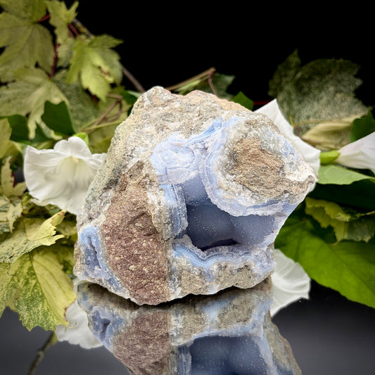 Natural Blue Lace Agate geode specimen with a prominent hollow cavity showing off light blue crystalline bands.