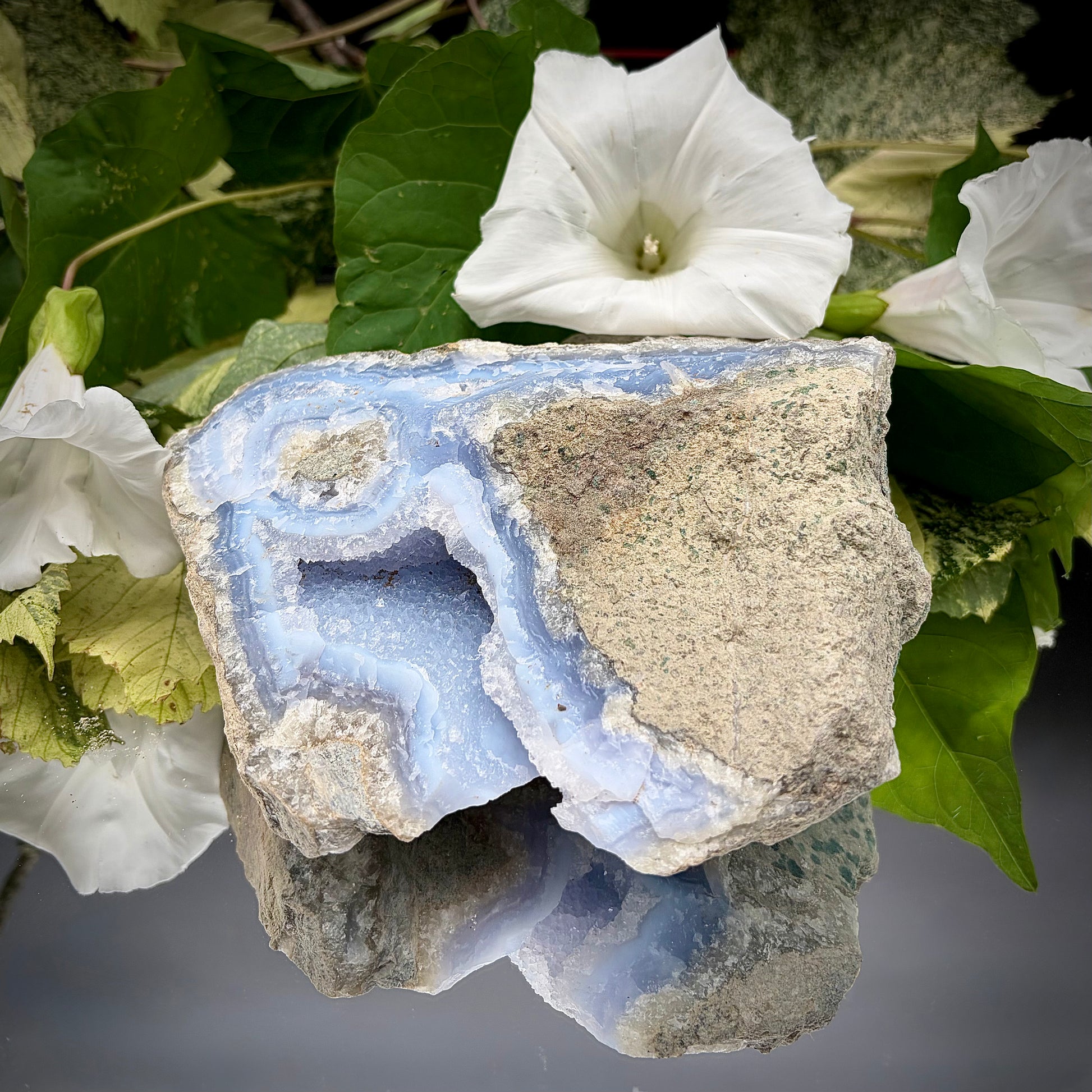 Natural Blue Lace Agate geode specimen with a prominent hollow cavity showing off light blue crystalline bands.