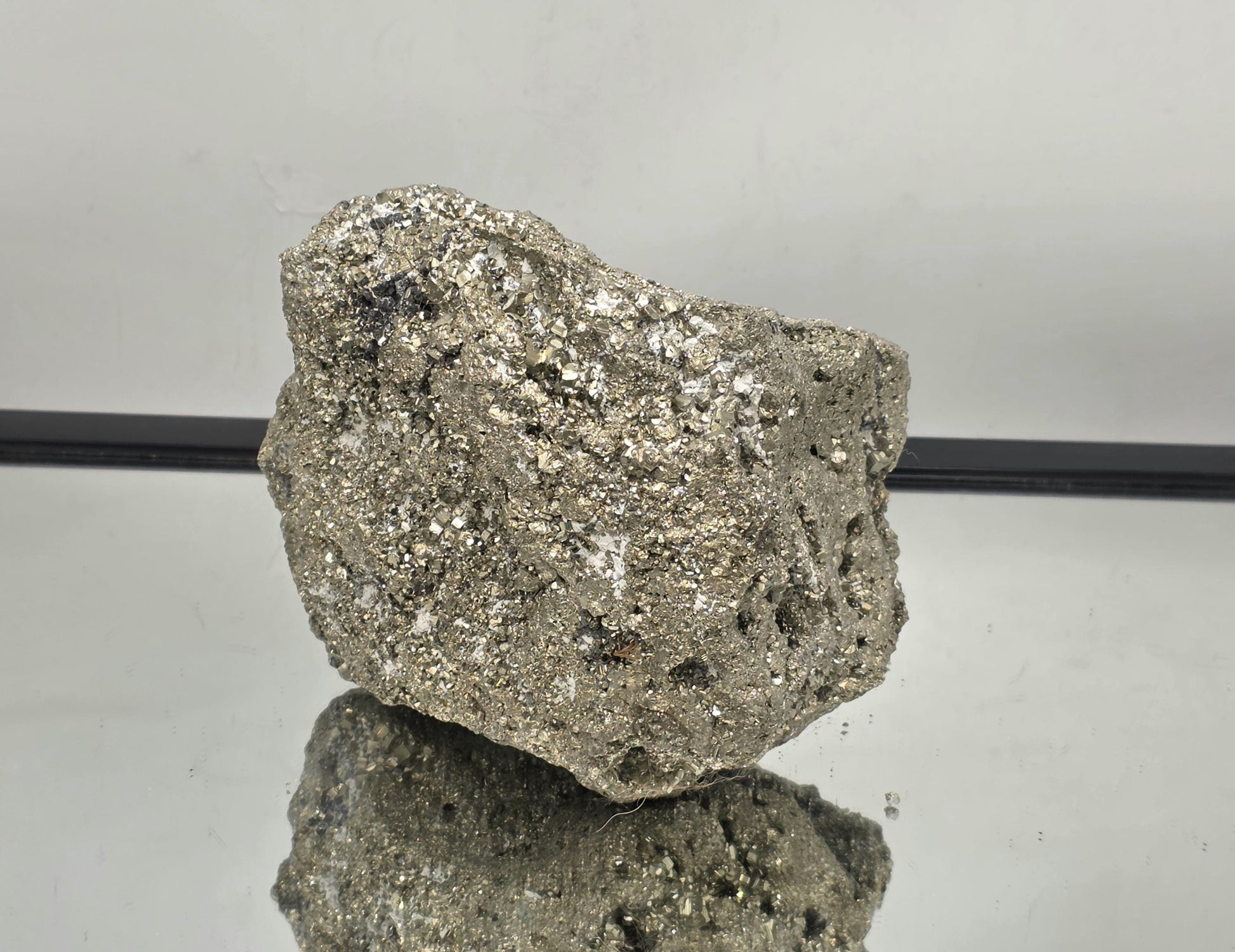 Close-up of raw Pyrite crystal surfaces and cubic formations.