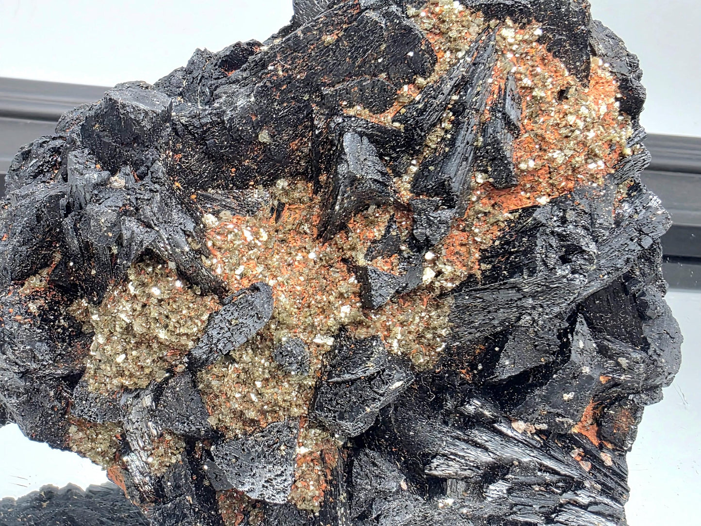 Raw black tourmaline crystal with mica inclusions, powerful protective stone.