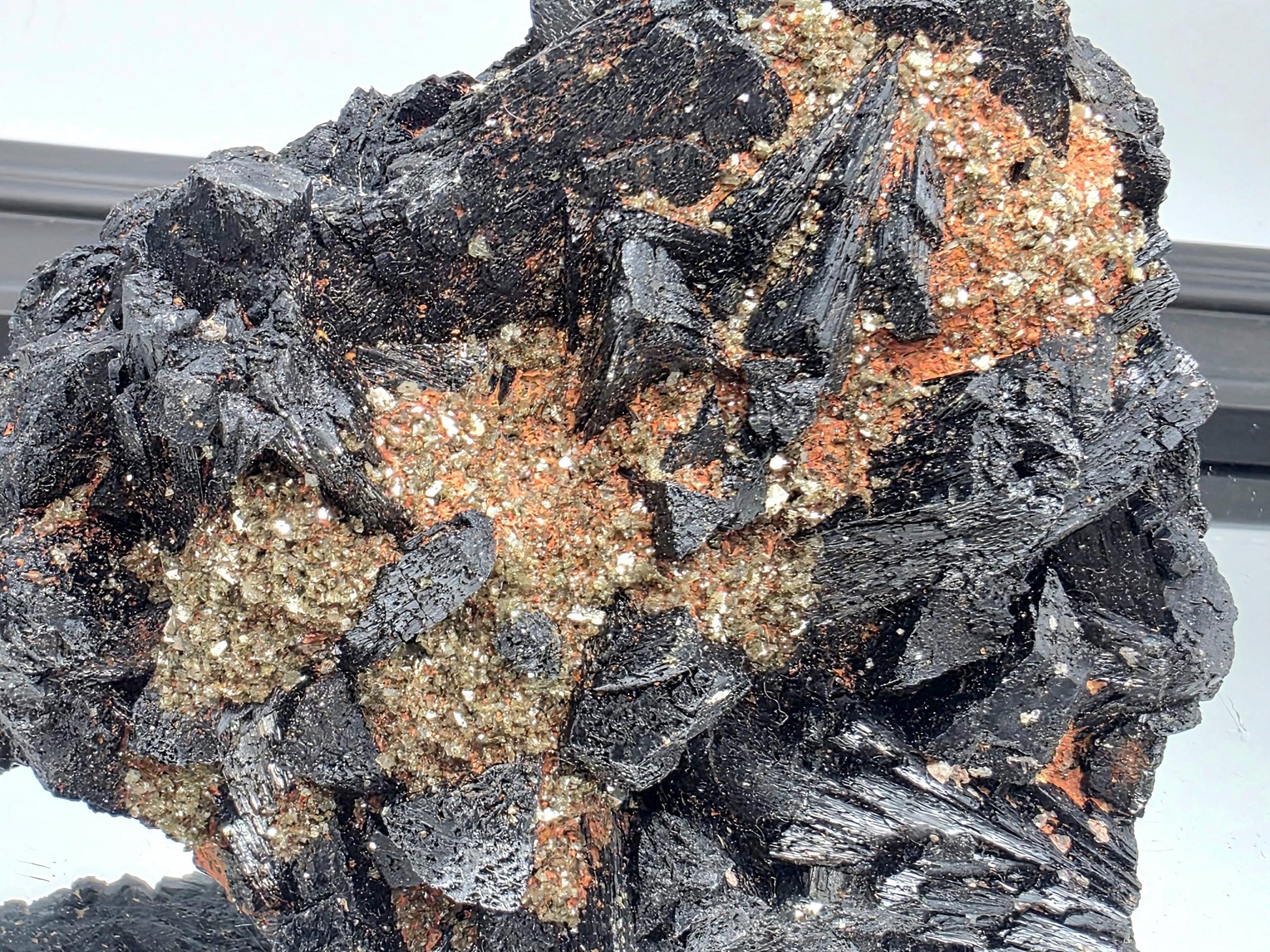 Raw black tourmaline crystal with mica inclusions, powerful protective stone.
