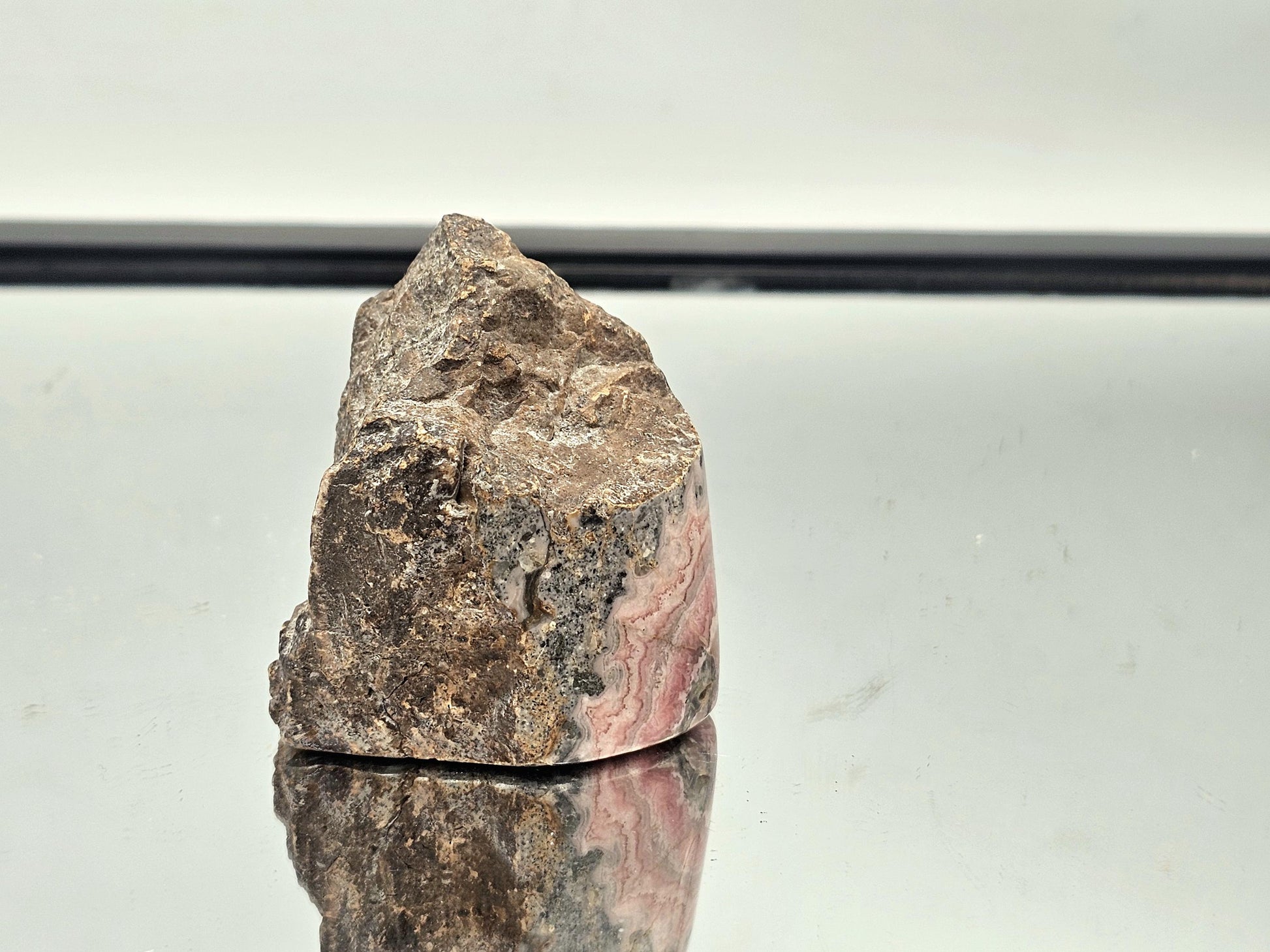 Polished Pink Rhodochrosite with natural matrix, a unique and stunning addition to any crystal collection.

