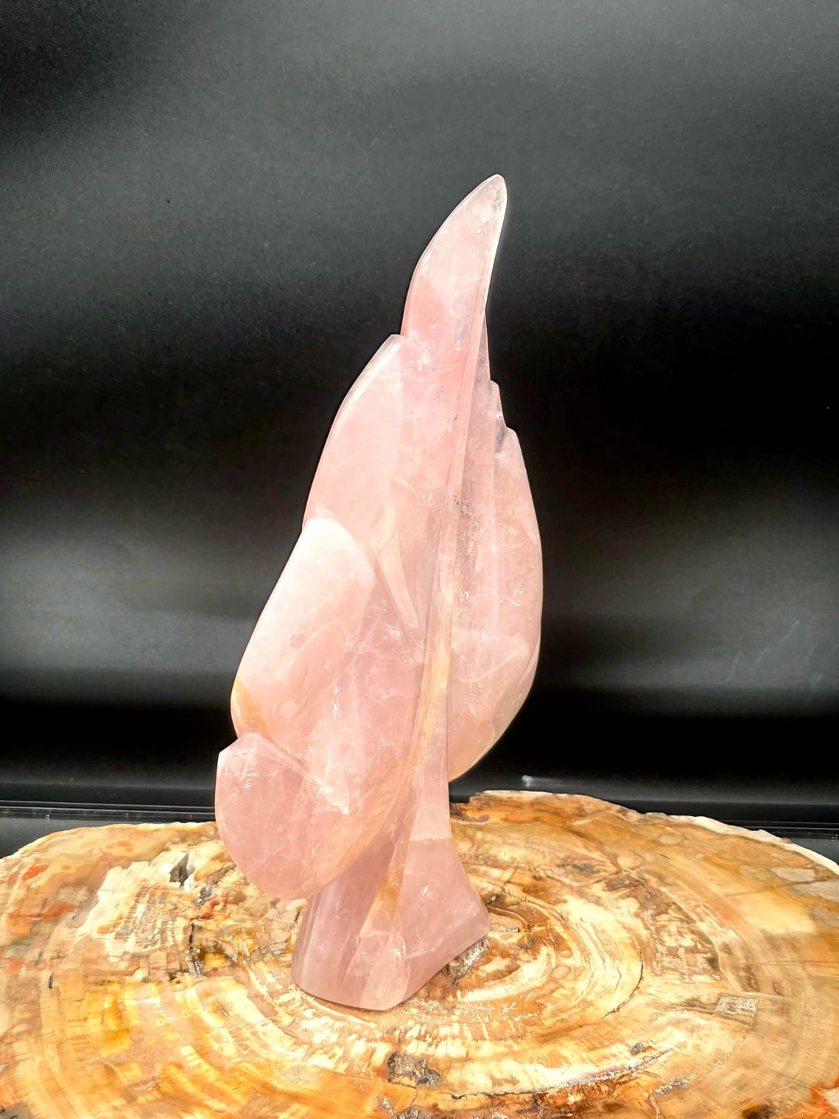 Side profile of a freestanding Rose Quartz crystal leaf with natural translucency.