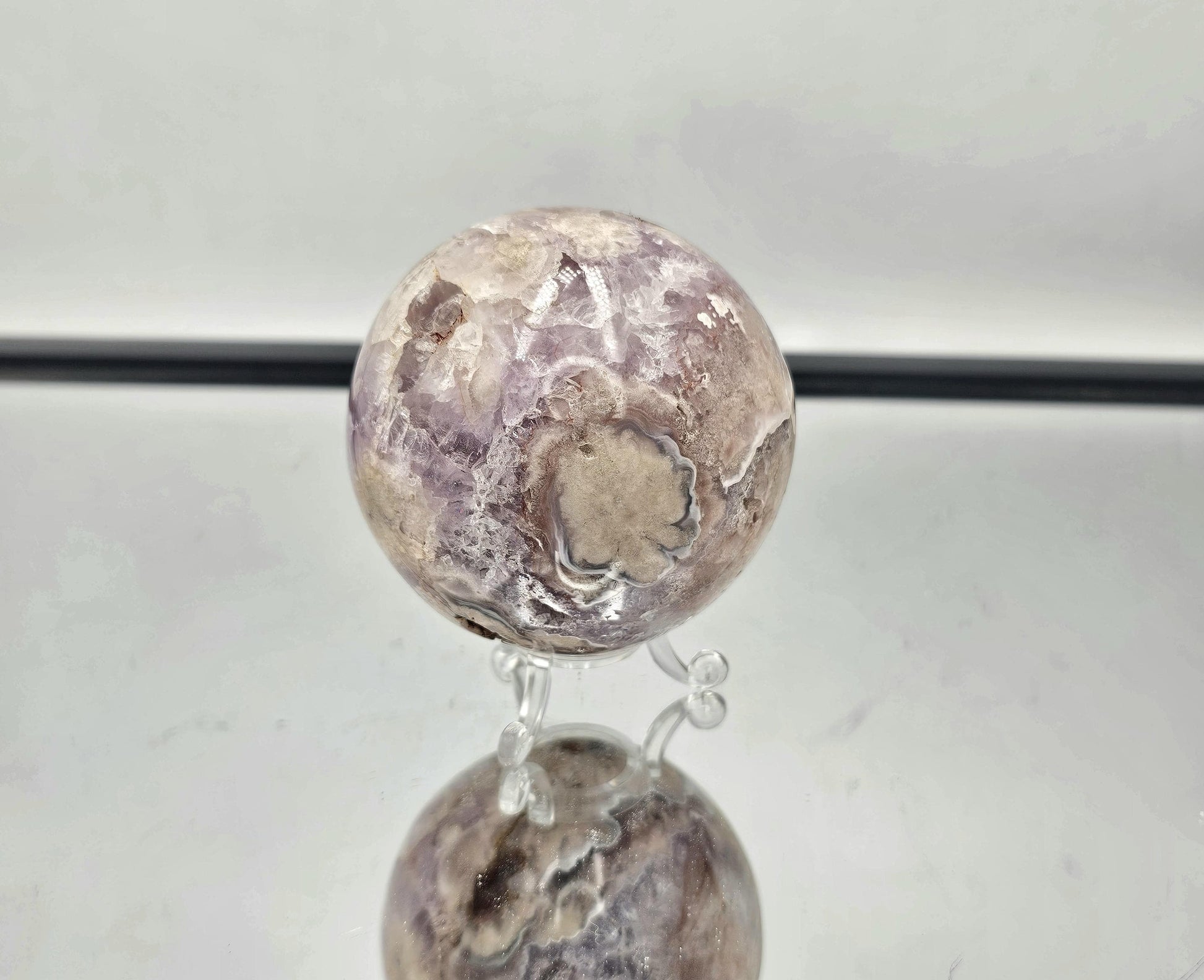 Unique Sakura Agate and Amethyst crystal sphere from Madagascar, featuring stunning natural details.