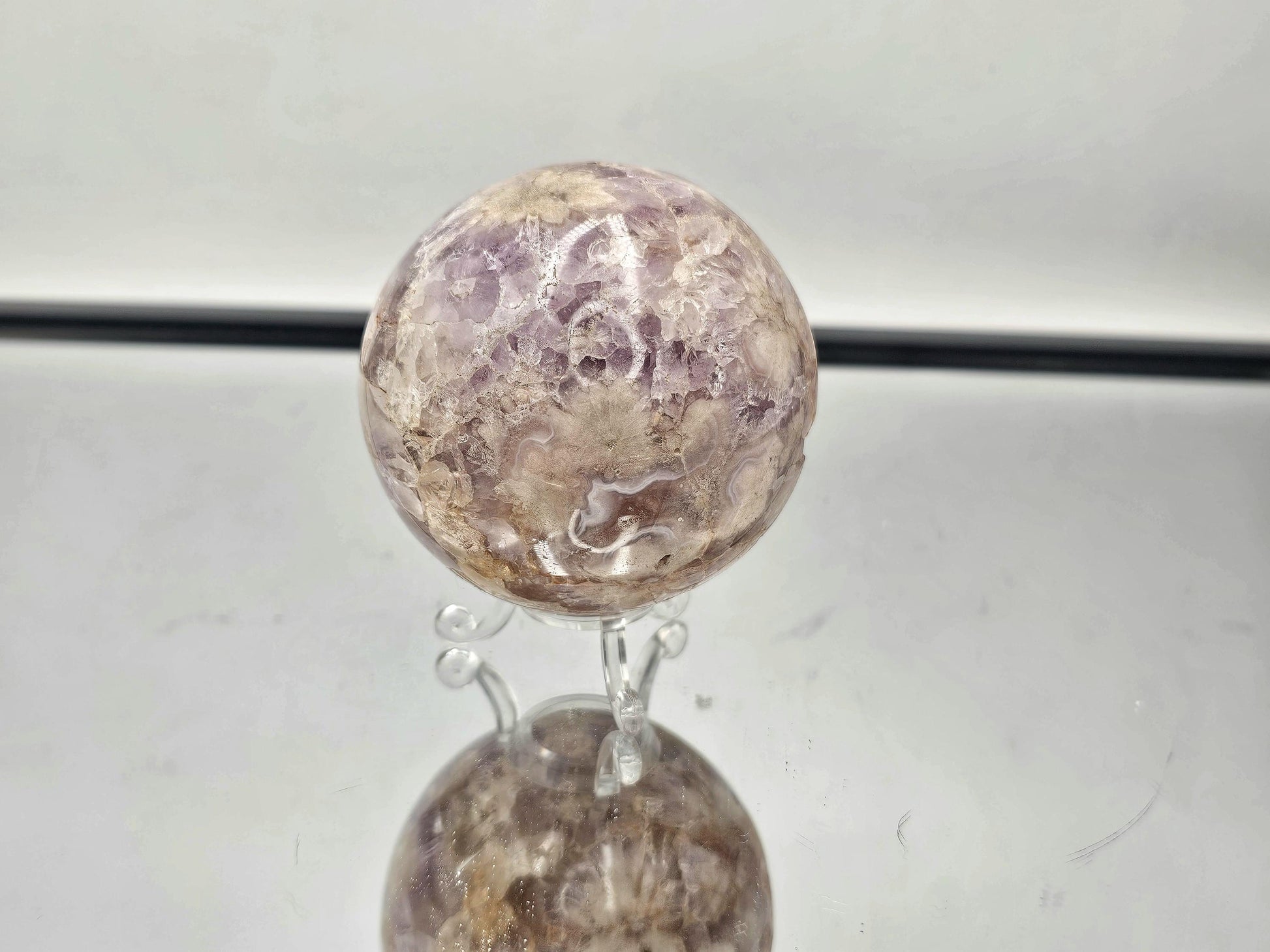 Close-up of the Sakura Agate and Amethyst sphere, highlighting the beautiful floral patterns and colors.
