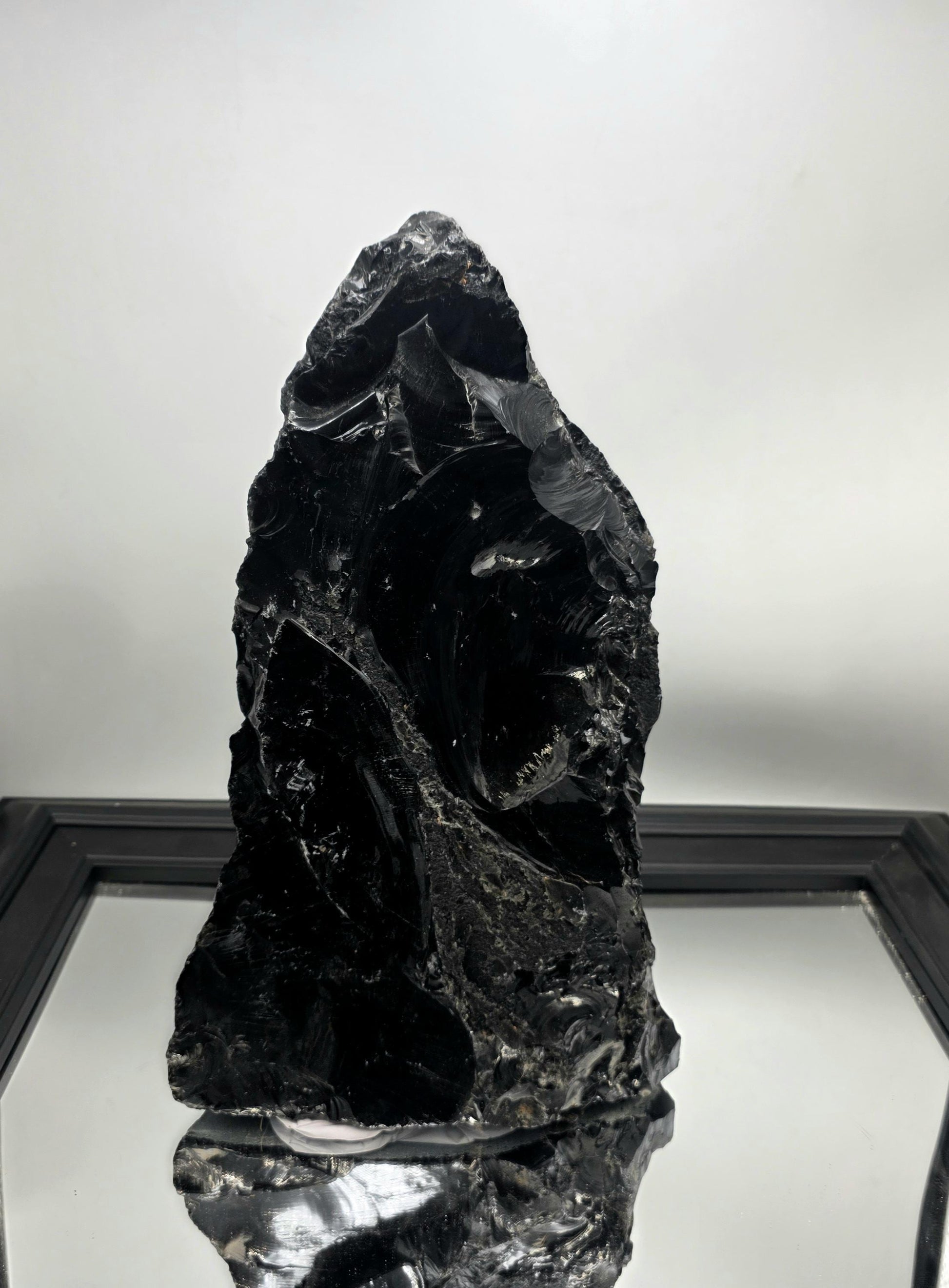 Raw stone decor piece used to anchor a shelf styling layout.
