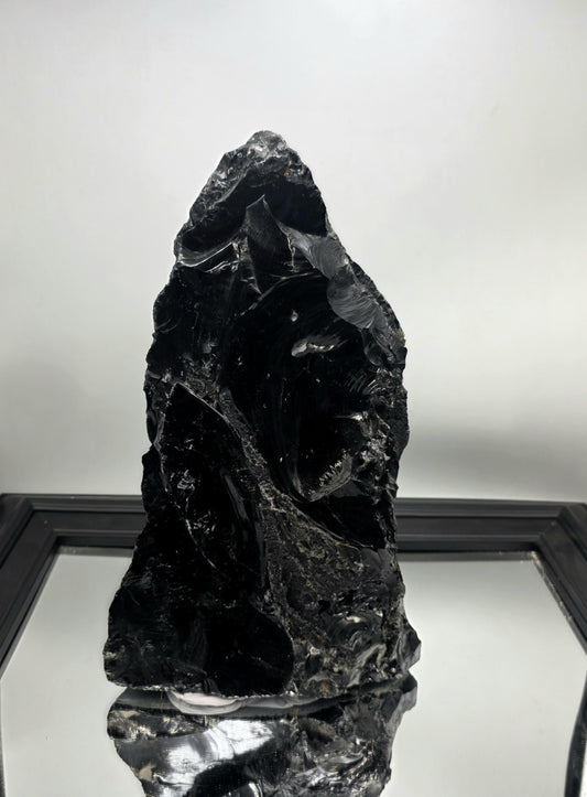 Raw stone decor piece used to anchor a shelf styling layout.