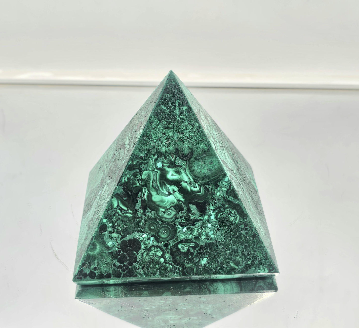 small unique malachite pyramid ideal for crystal collectors and interior design.