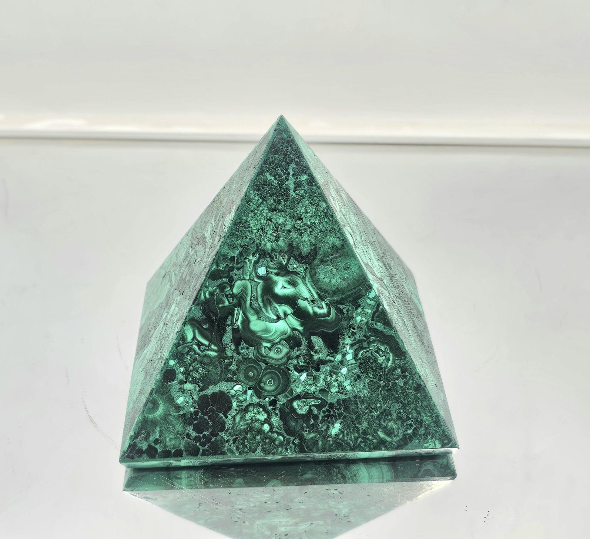 small unique malachite pyramid ideal for crystal collectors and interior design.