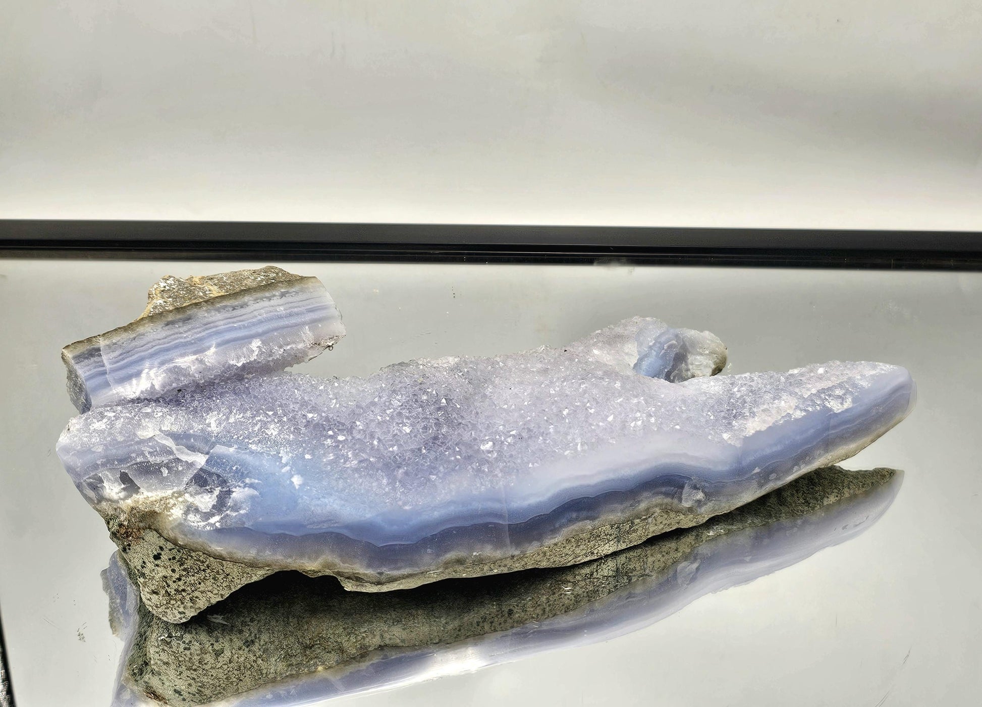 Sparkling Quartz Crystal druzy in a Blue Lace Agate geode, ideal for luxury interior design.