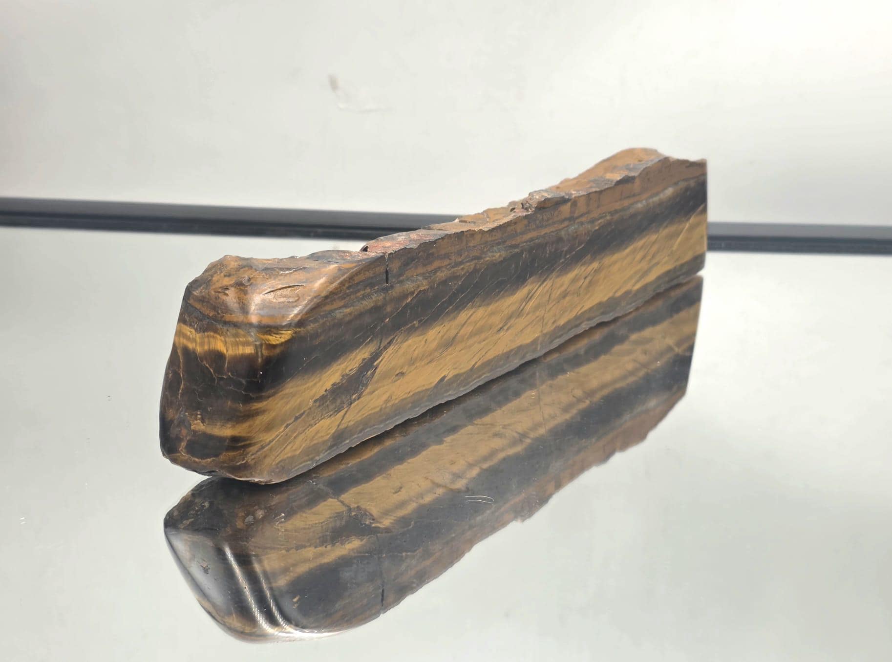 Polished Tiger’s Eye crystal with rich brown and gold tones