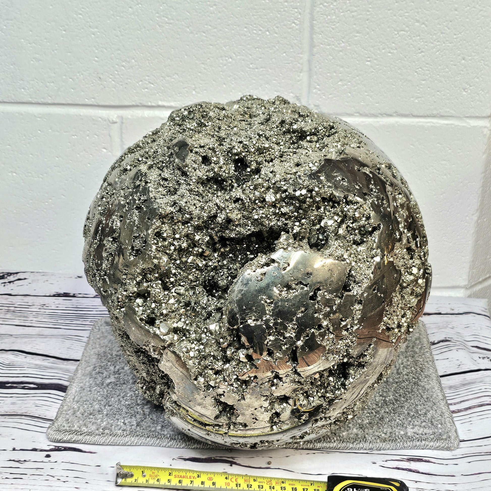 Rare 64kg pyrite crystal sphere with included display stand.