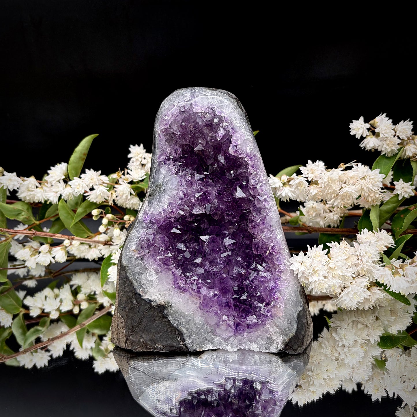 Deep purple Uruguayan amethyst crystal geode with a cut base.