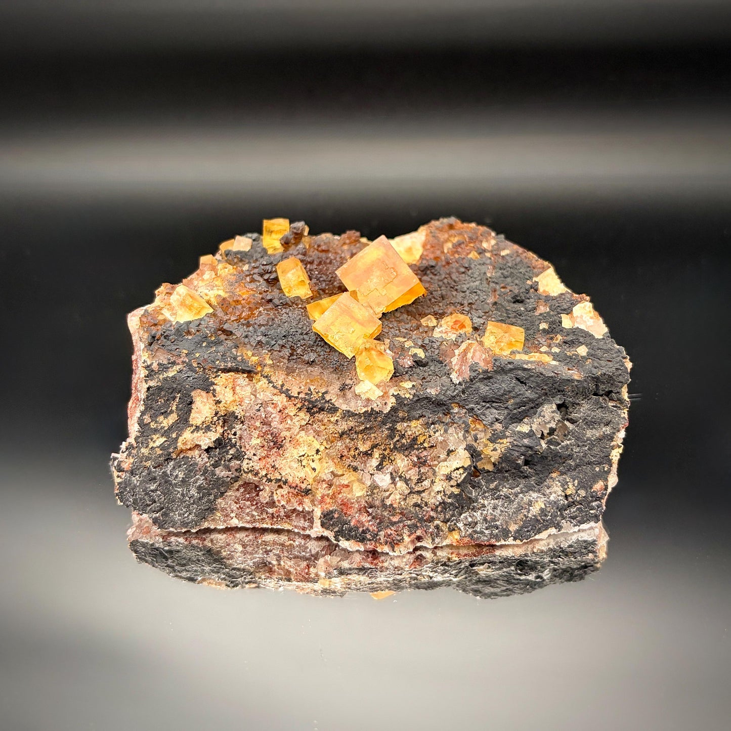 UV reactive Golden Yellow Fluorite on Black Hematite Matrix.