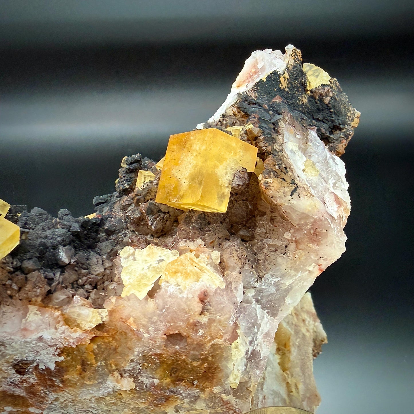 UV reactive Golden Fluorite specimen on natural matrix