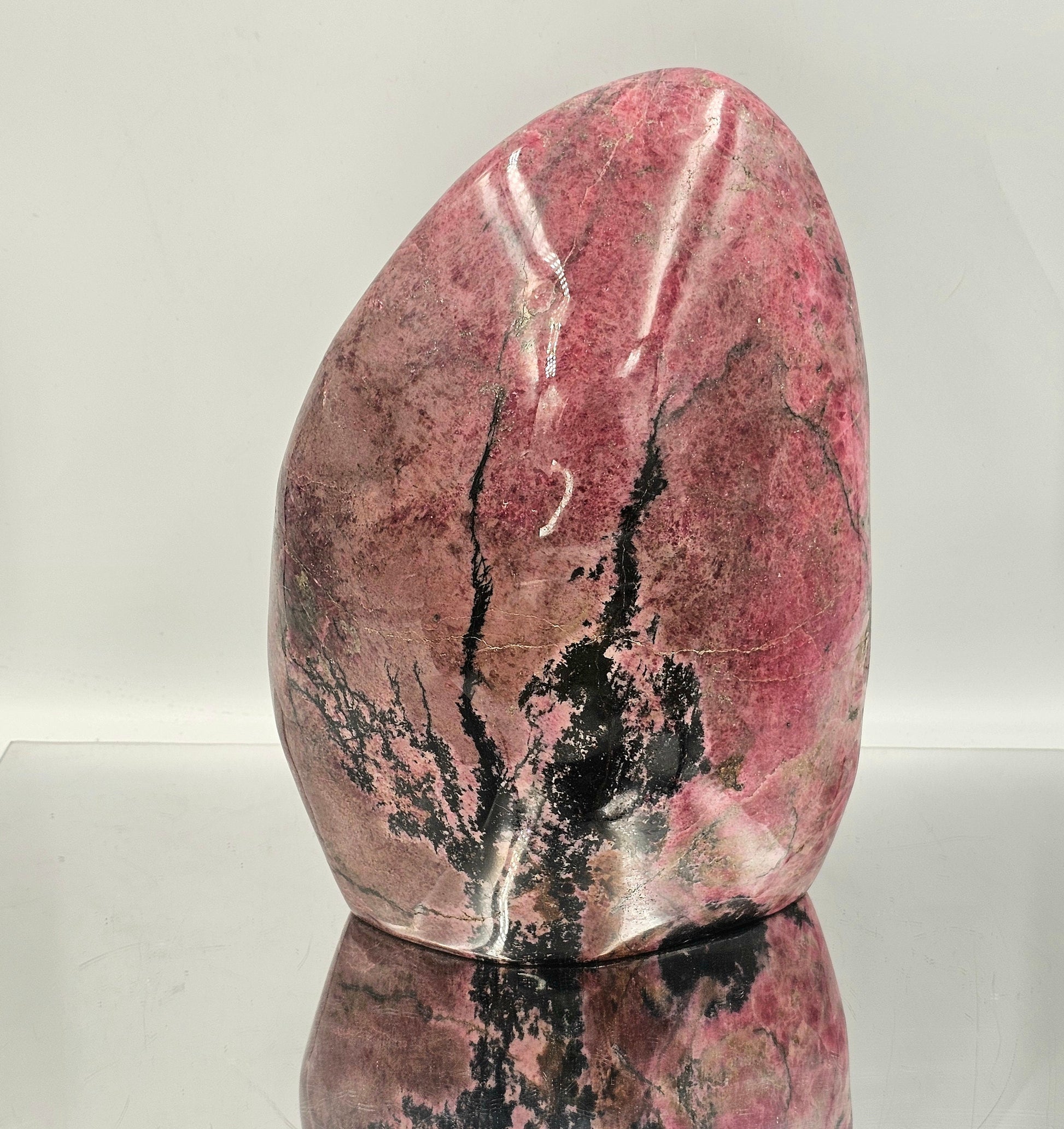 very large pink and black rhodonite crystal freeform