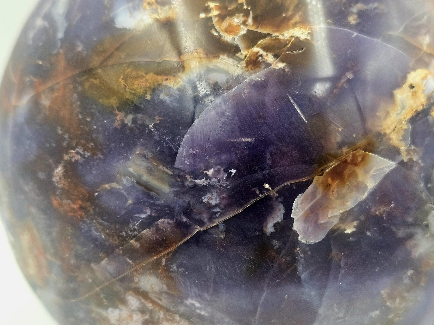 violet agate crystal ball with unique veils and inclusions for collectors and enthusiasts