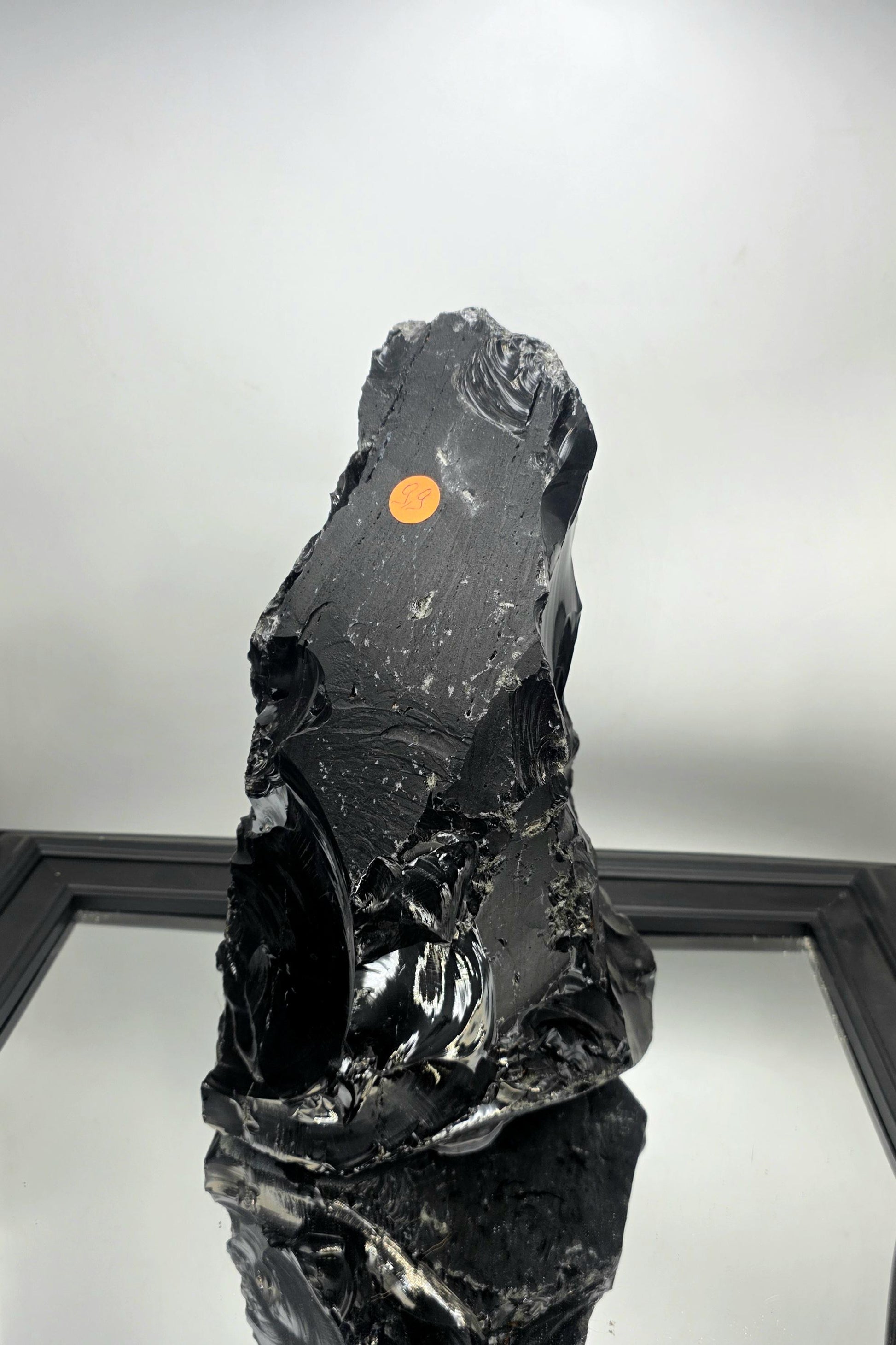 Raw obsidian crystal styled with linen textures in a wabi-sabi interior.