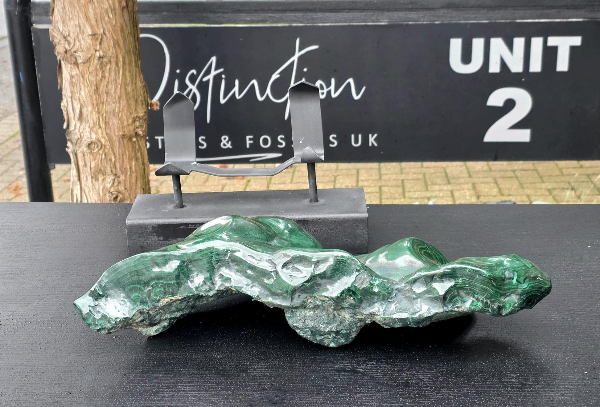 Close-up of polished Malachite crystal showing natural green banded patterns