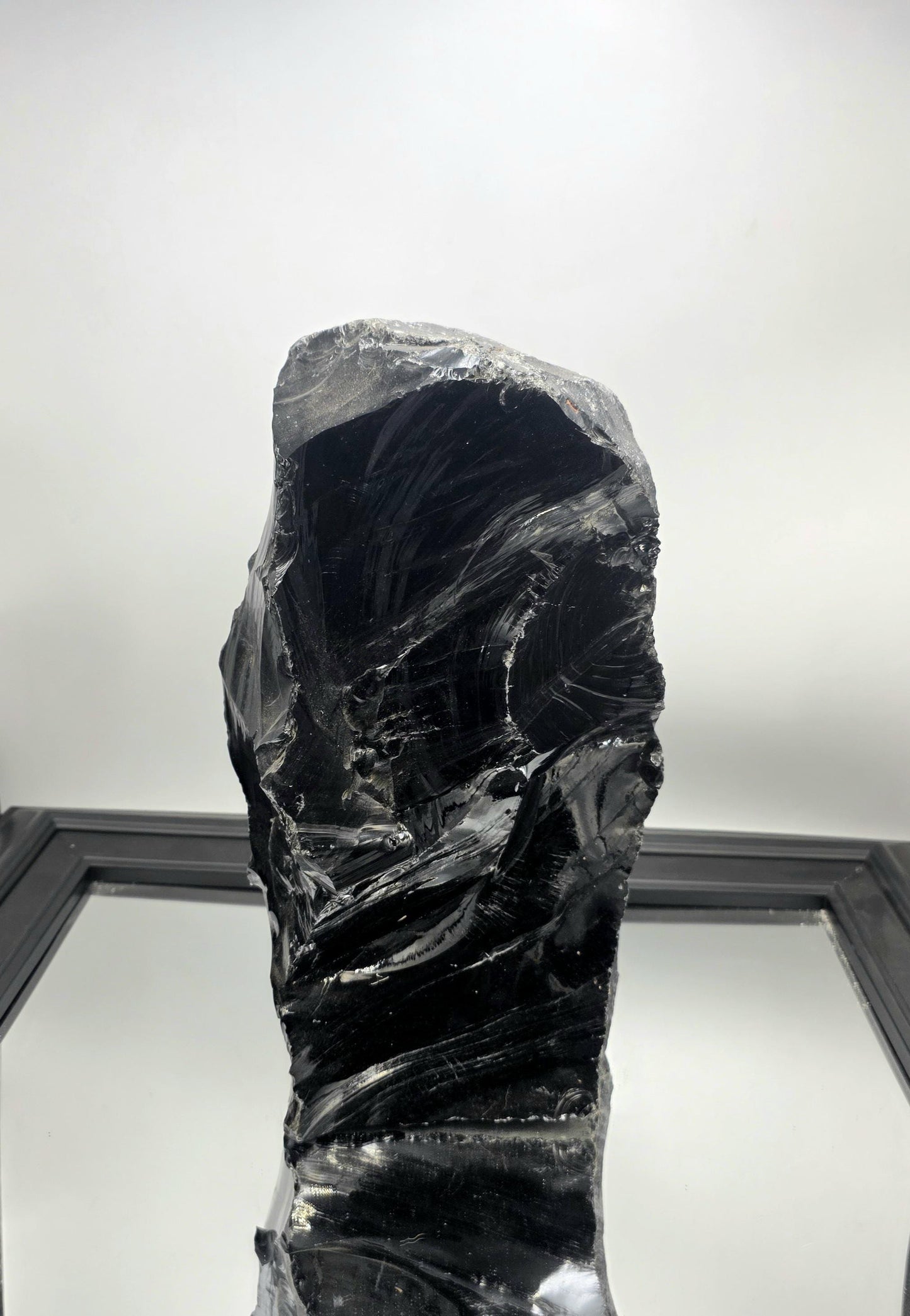 XL Obsidian crystal styled on a minimalist white console table with ambient lighting.
