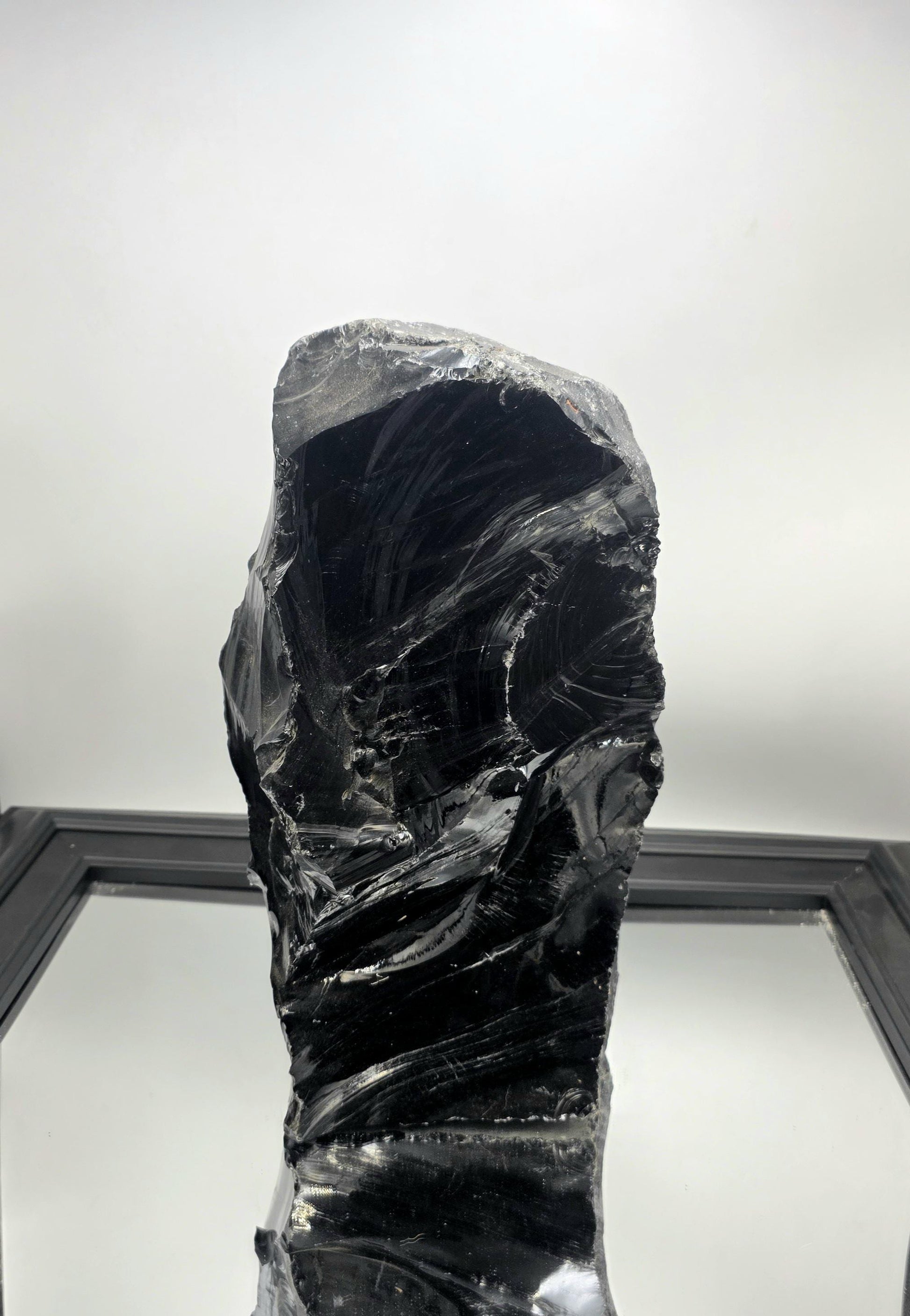 XL Obsidian crystal styled on a minimalist white console table with ambient lighting.