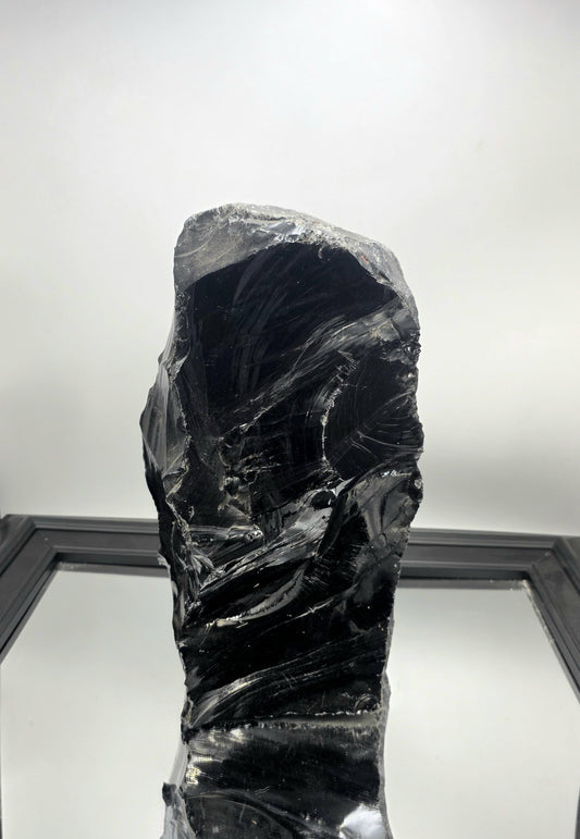 XL Obsidian crystal styled on a minimalist white console table with ambient lighting.
