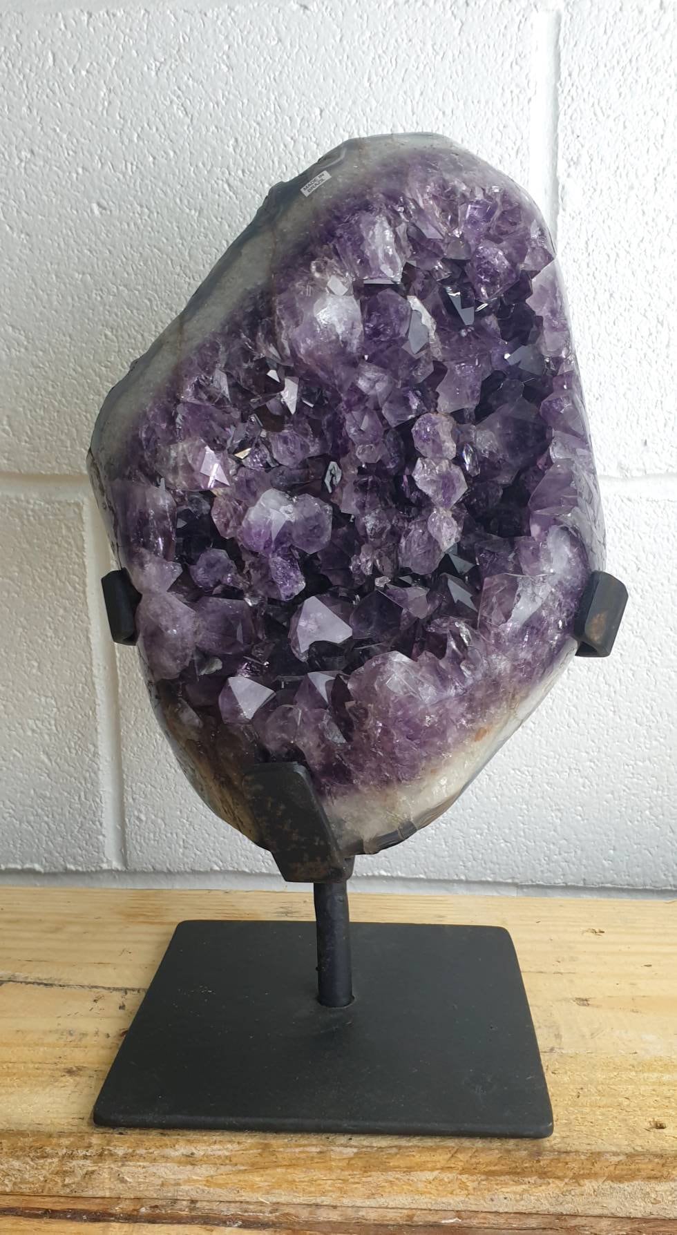 large amethyst interior crystals on metal stand